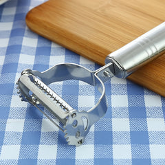 Close-up of the stainless steel peeler's toothed blade