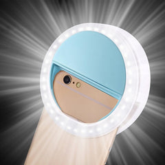 Blue clip-on LED selfie ring light lit up on a phone