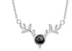 Silver tone reindeer antler pendant necklace with dark centre stone