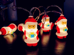 Lit Santa string lights on a table