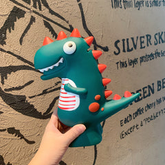Dinosaur piggy bank held from below, front view
