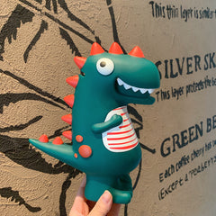 Small dinosaur piggy bank held in one hand