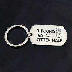 Silver-tone I found my otter half keychain tag on a dark background