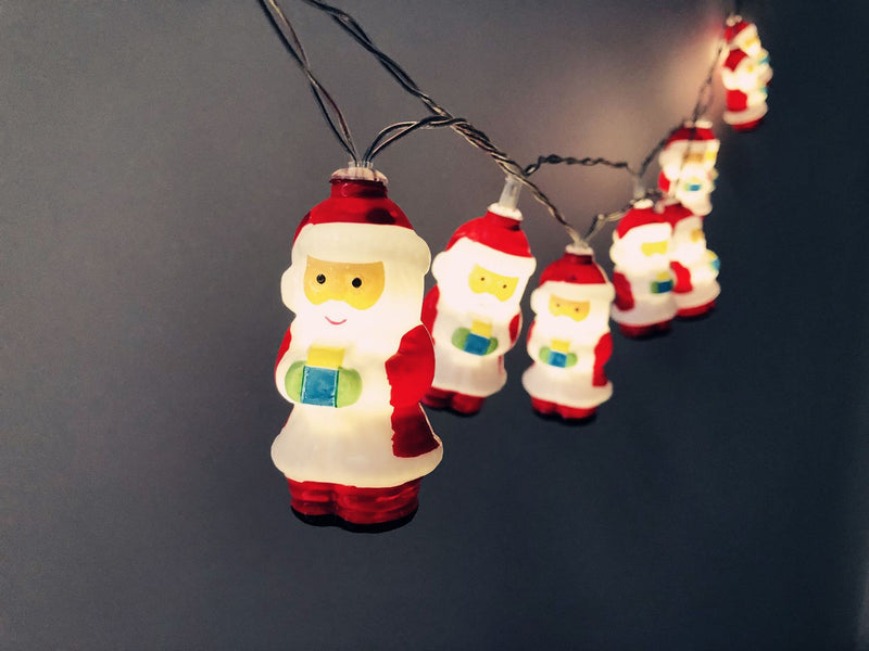 Santa LED string lights glowing against a dark wall