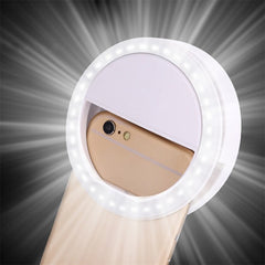 White clip-on LED selfie ring light lit up on a phone