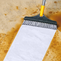 Floor brush scraping a wet, dirty floor
