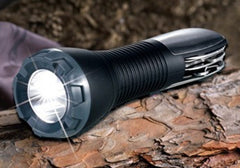 LED multi-tool flashlight shining on a log