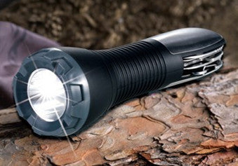 LED multi-tool flashlight shining on a log