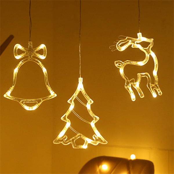 Bell, tree and reindeer LED window lights glowing
