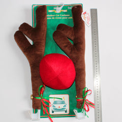 Brown car antler set next to a ruler
