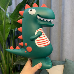 Large dinosaur piggy bank held in one hand in front of a plant