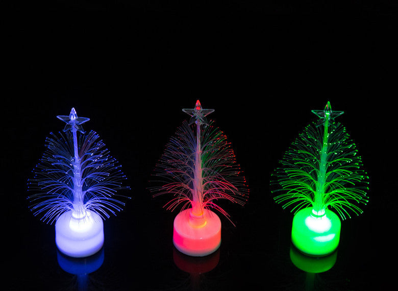 White, red and green lit fibre optic trees
