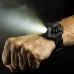 LED wrist flashlight shining from a man's wrist