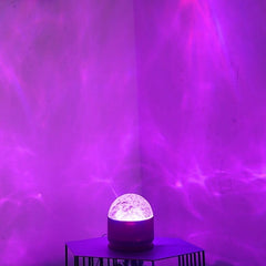Night light on a side table casting purple water ripple light across the walls