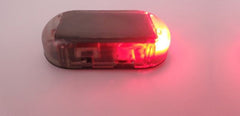 Solar decoy LED light with red light on