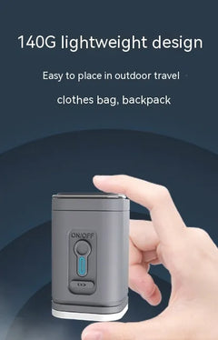 Grey mini air pump held in one hand