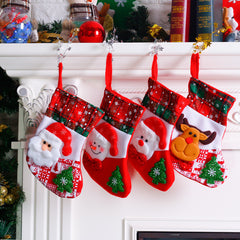 Four mini Christmas stockings hanging from a mantel
