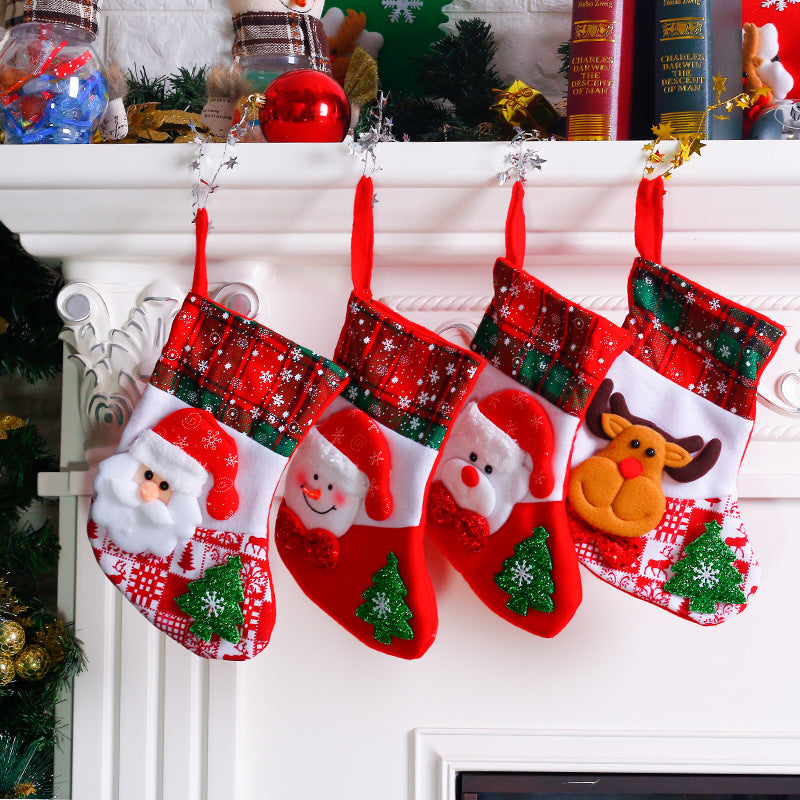 Four mini Christmas stockings hanging from a mantel