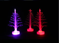 Purple and red mini fibre optic Christmas trees glowing