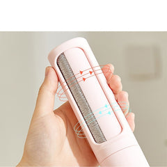 Hand holding the pink pet hair lint brush showing the fabric pad