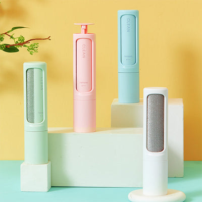Plastic pet hair lint brushes in green, pink, blue and white